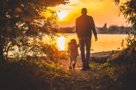 father-and-child-walking-at-sunset